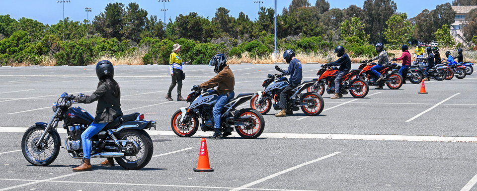 Motorcycle training area with riders preparing for a lesson.
